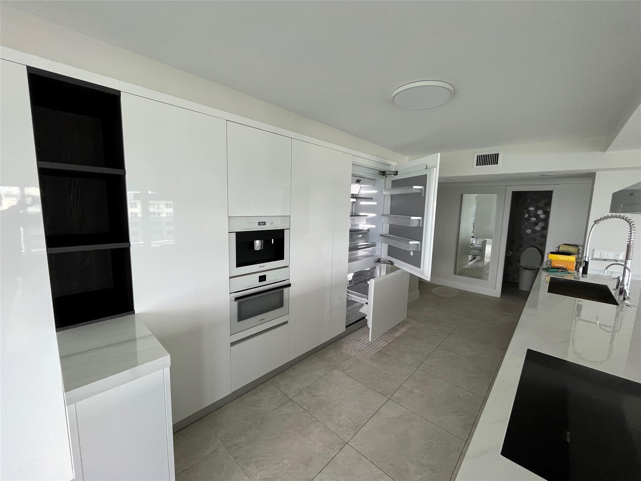 The refrigerator opened to show how it is concealed when closed.