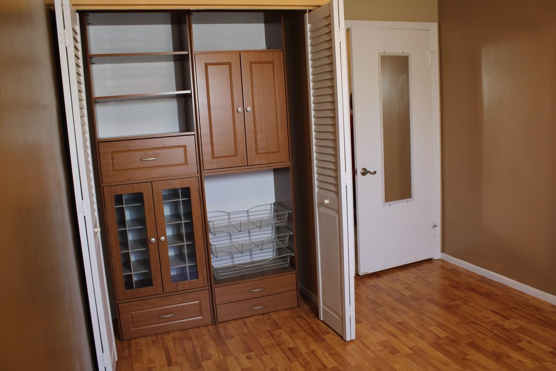 Photo for 8620 SW 12 Street, Pembroke Pines, FL 33025 - Listing #FX-10517624 Laminate floors with a warm oak tone and custom shelving in the closet.