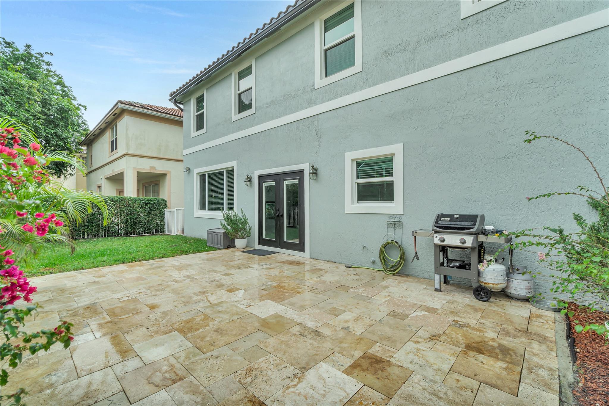 Large Backyard with travertine and grass area