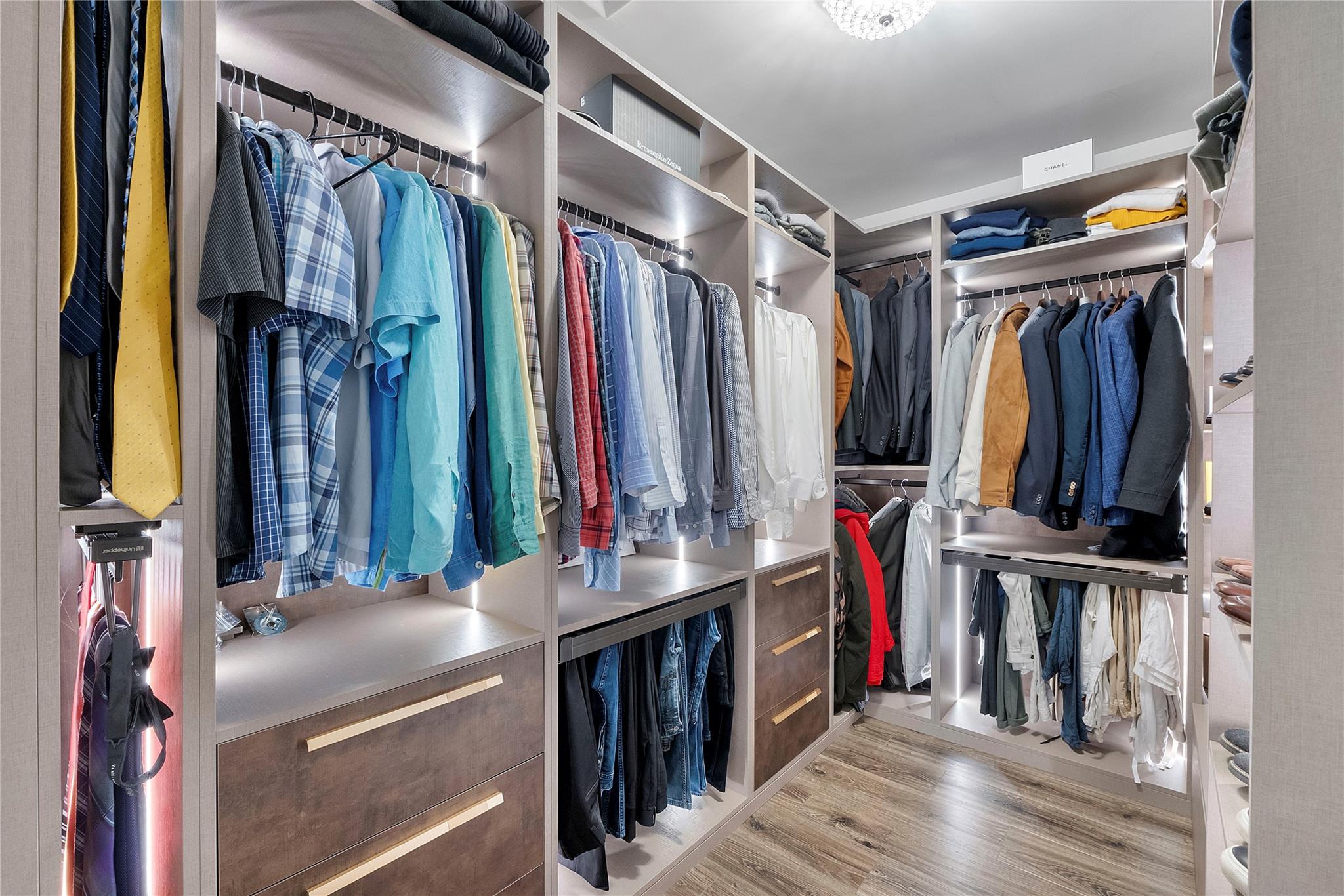 Separate spacious custom designer closets with lighting for him,, lots of storage space for winter clothes
