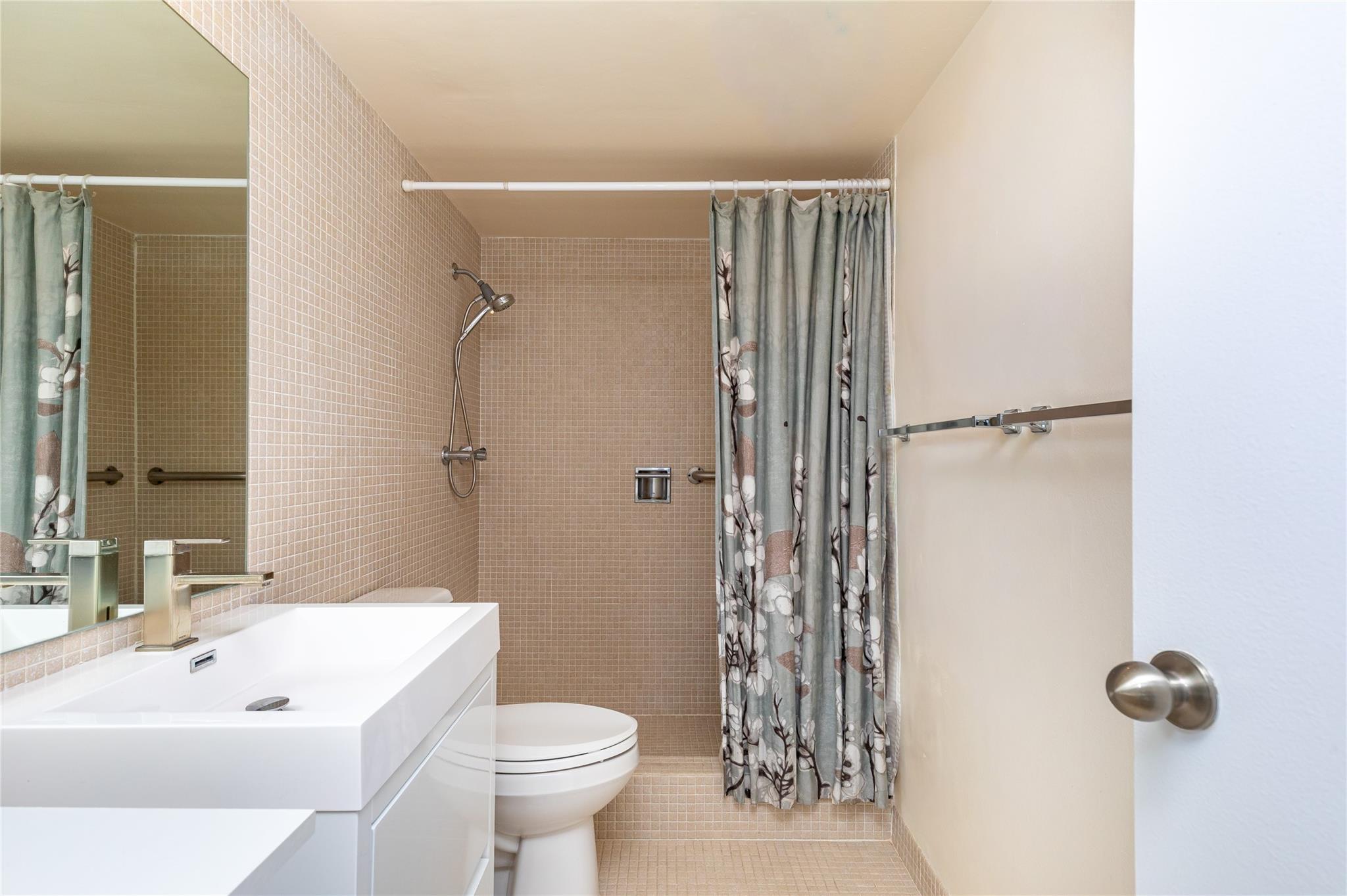 Primary bathroom with updated modern vanity.
