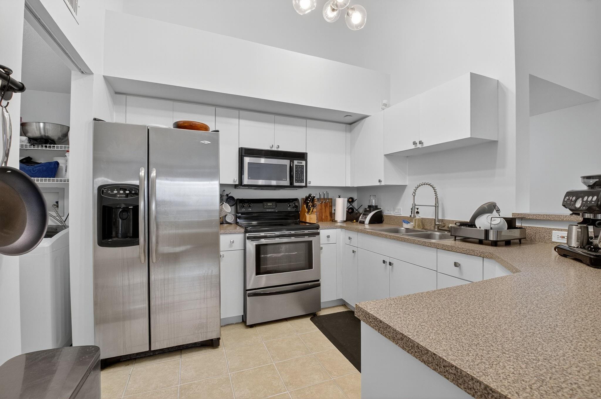 The Kitchen features stainless steel appliances and freshly painted white cabinets.