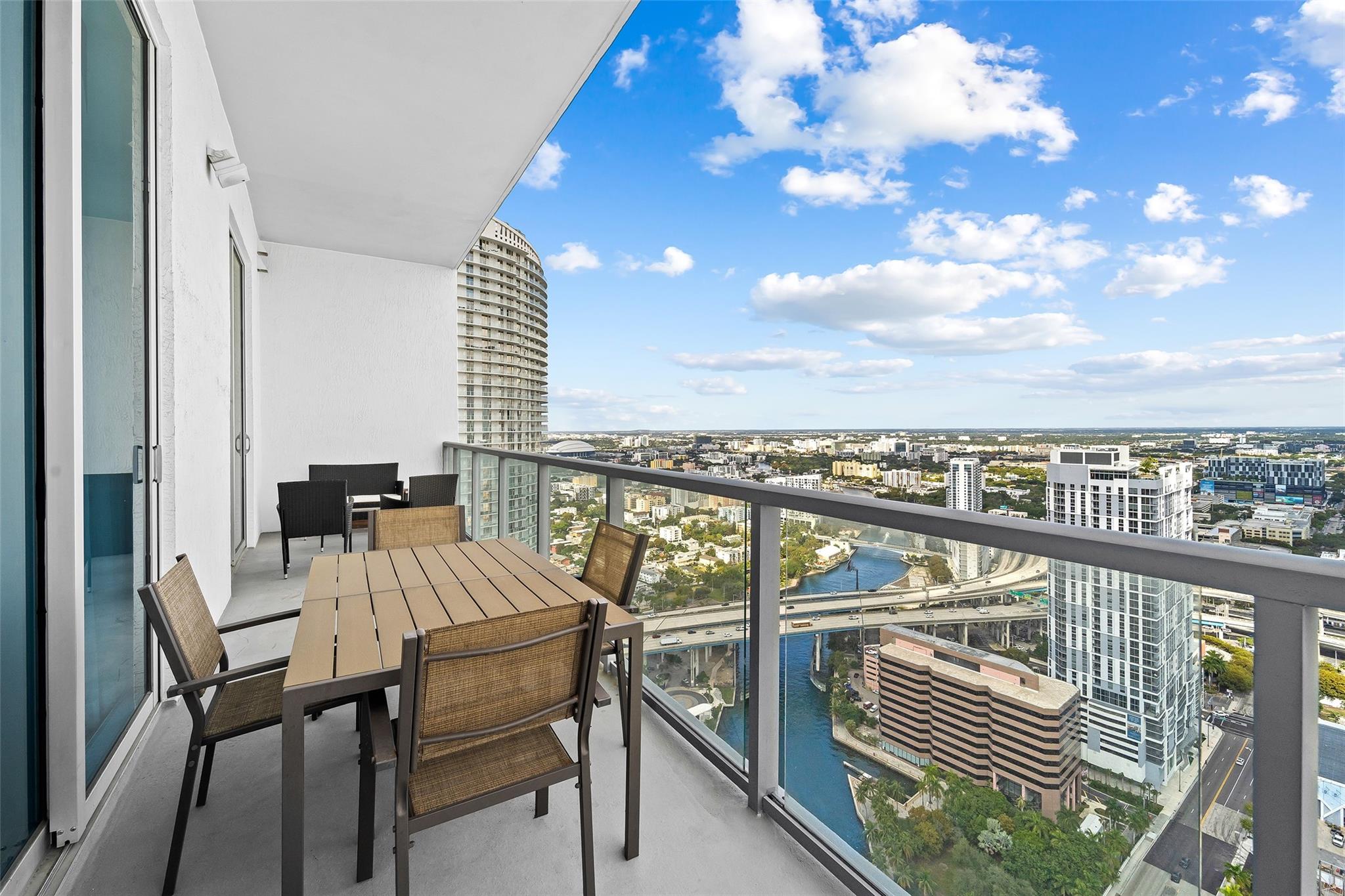 Oversized balcony with room for multiple outdoor spaces, panoramic views of Miami from East to West