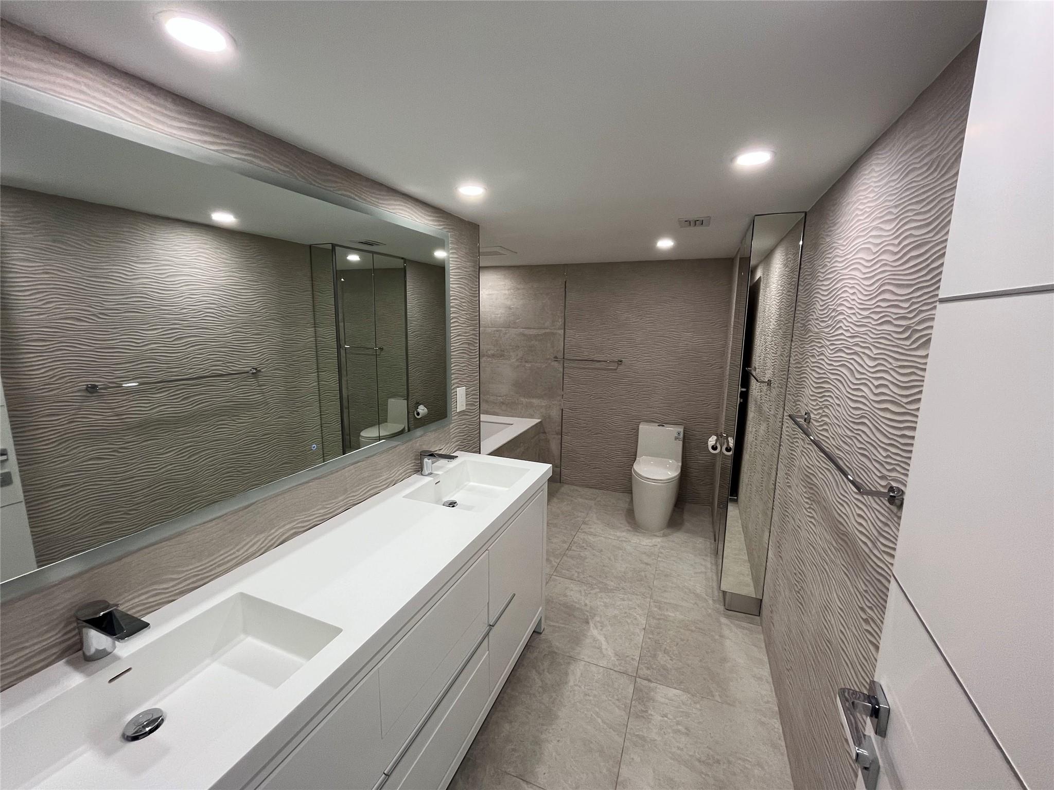 The large master bathroom includes two sinks and plenty of storage.