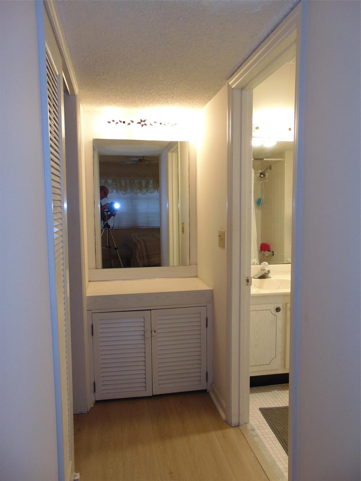 DRESSING AREA AT WALK IN CLOSET BY MASTER BATHROOM