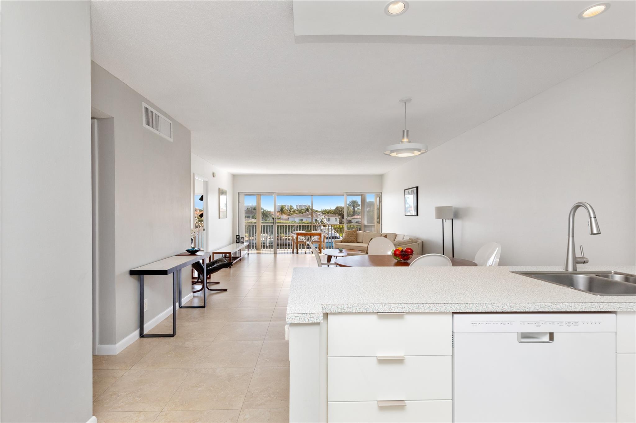 Kitchen in foreground with dining and living areas in background to gorgeous views.