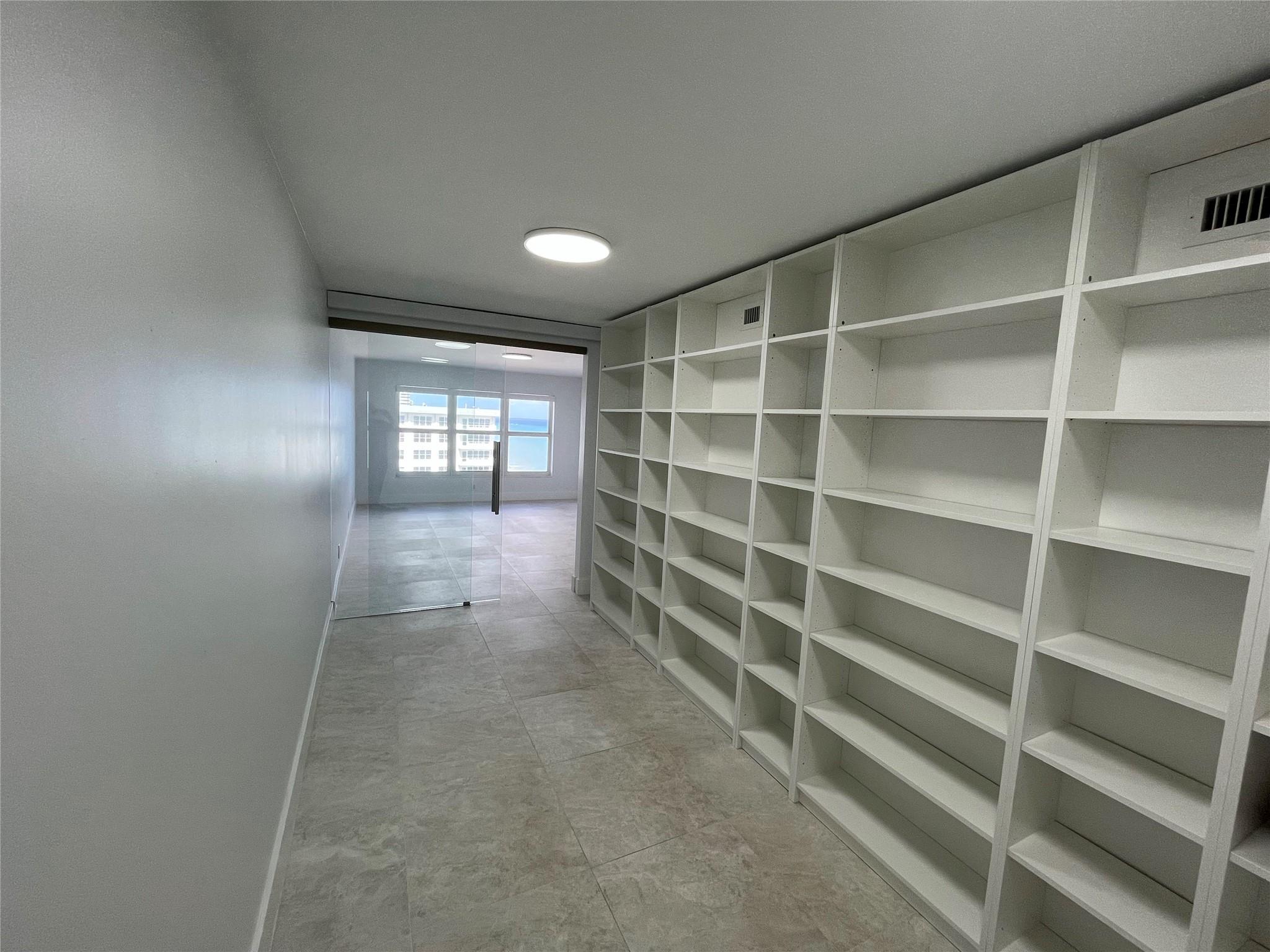 The room features wall-to-ceiling built-in shelving.