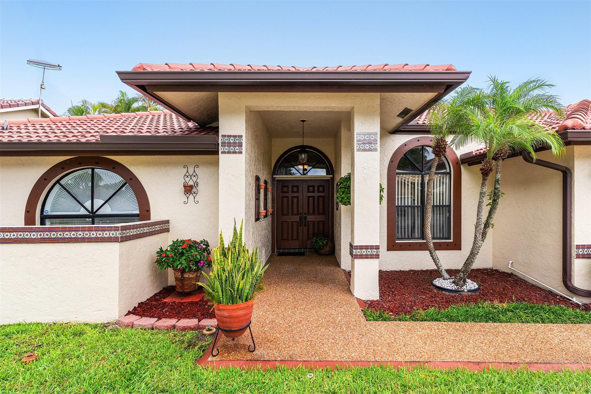 Double Door Hurricane impact front doors welcome you home! Outstanding curb appeal!