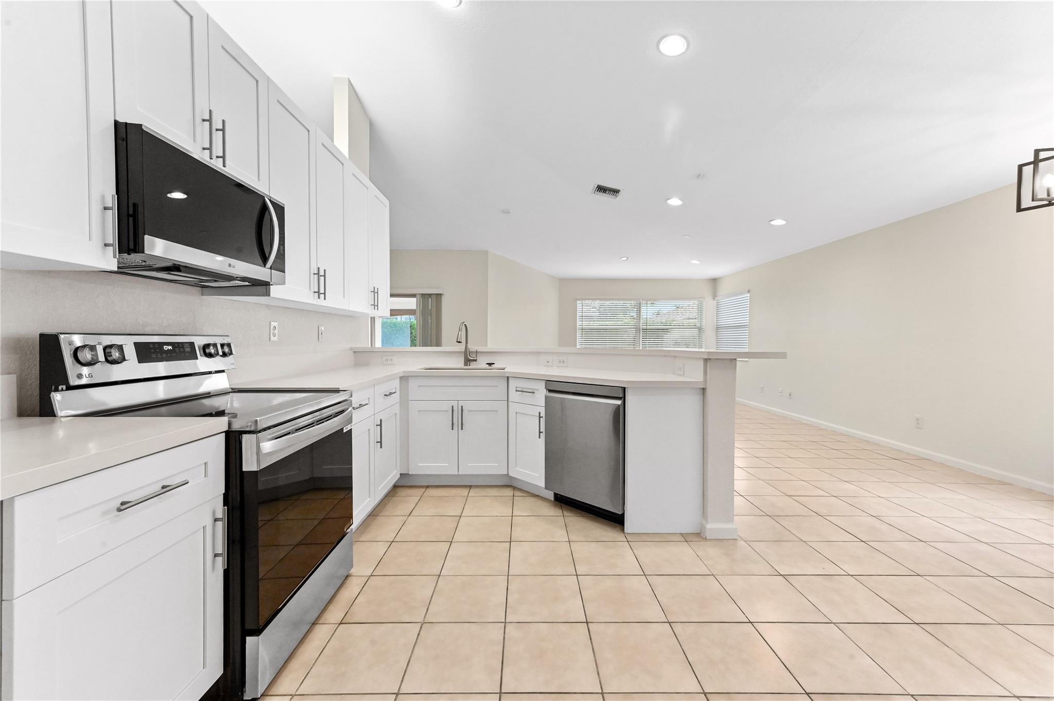 Updated kitchen with wood cabinets, quartz counters and brand new stainless steel appliances