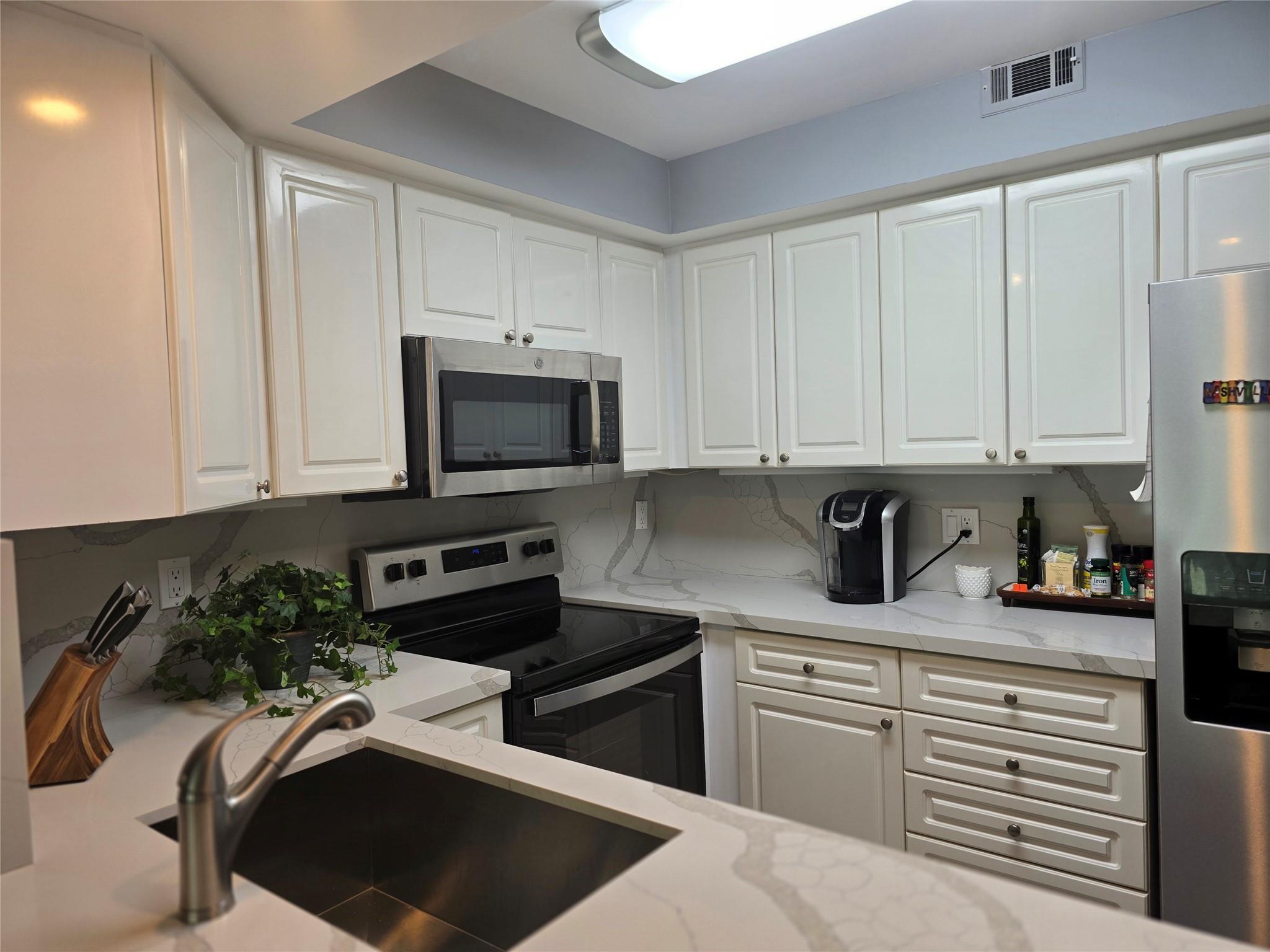 Creative kitchen w/ ample storage and SS appliances.