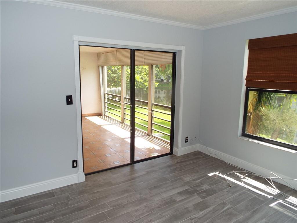 Photo for 2311 S Cypress Bend Drive, 219A, Pompano Beach, FL 33069 - Listing #FX-10412204 Living Room w/ Water Views & Glass Doors to Patio