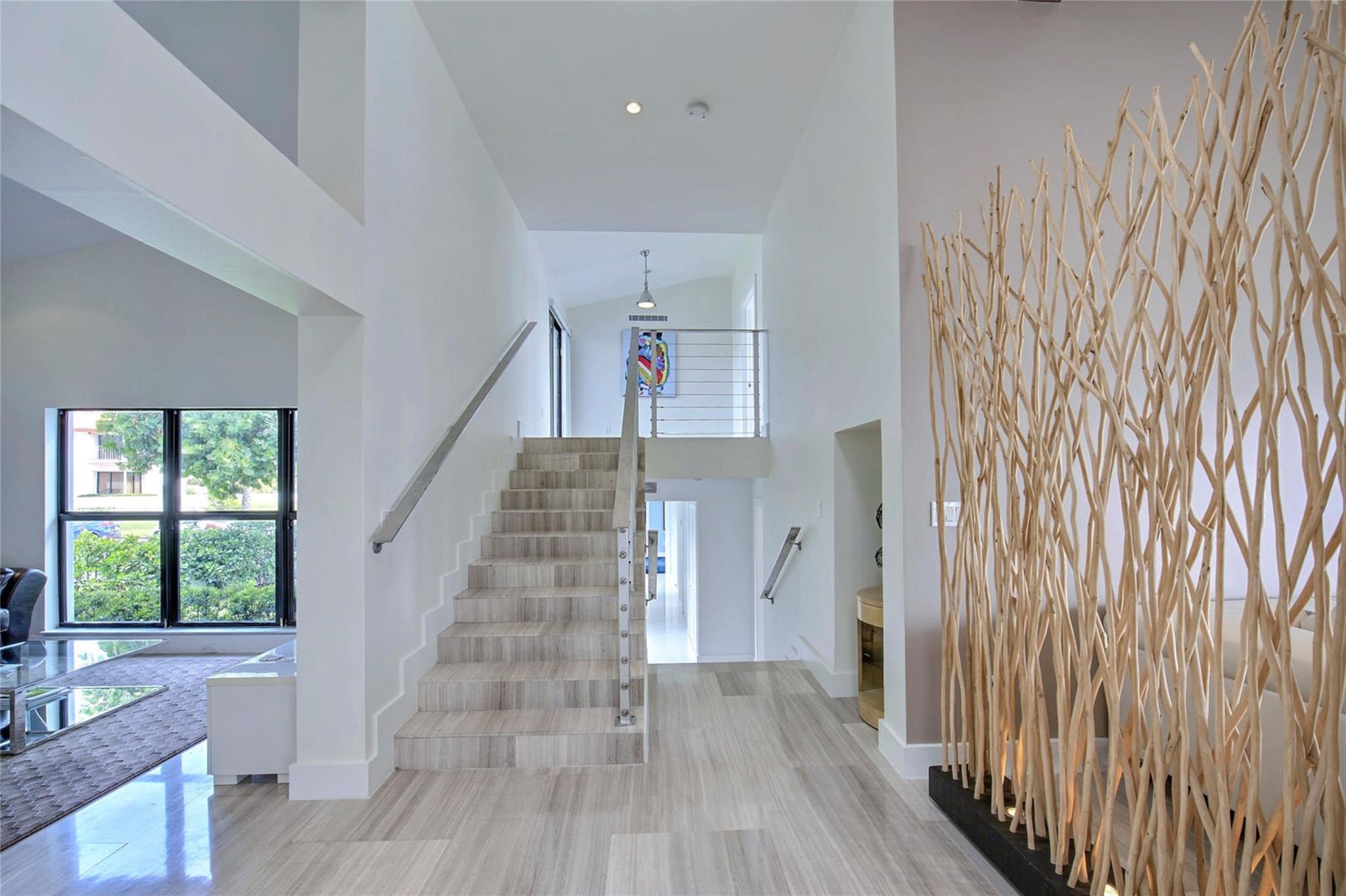 Up to Primary Bedroom and down to three Guest Rooms