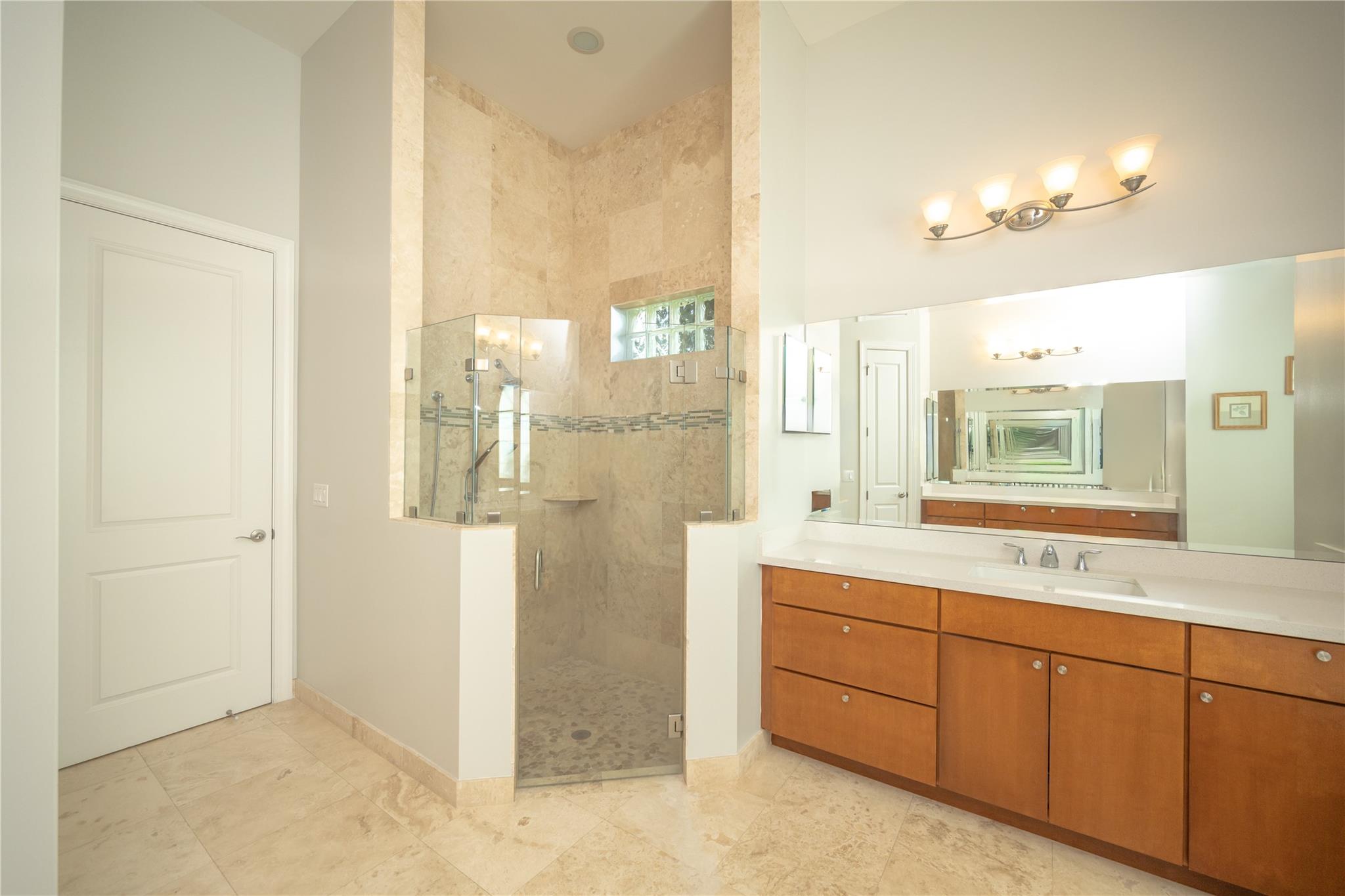 Master Bathroom shower with up to ceiling tile