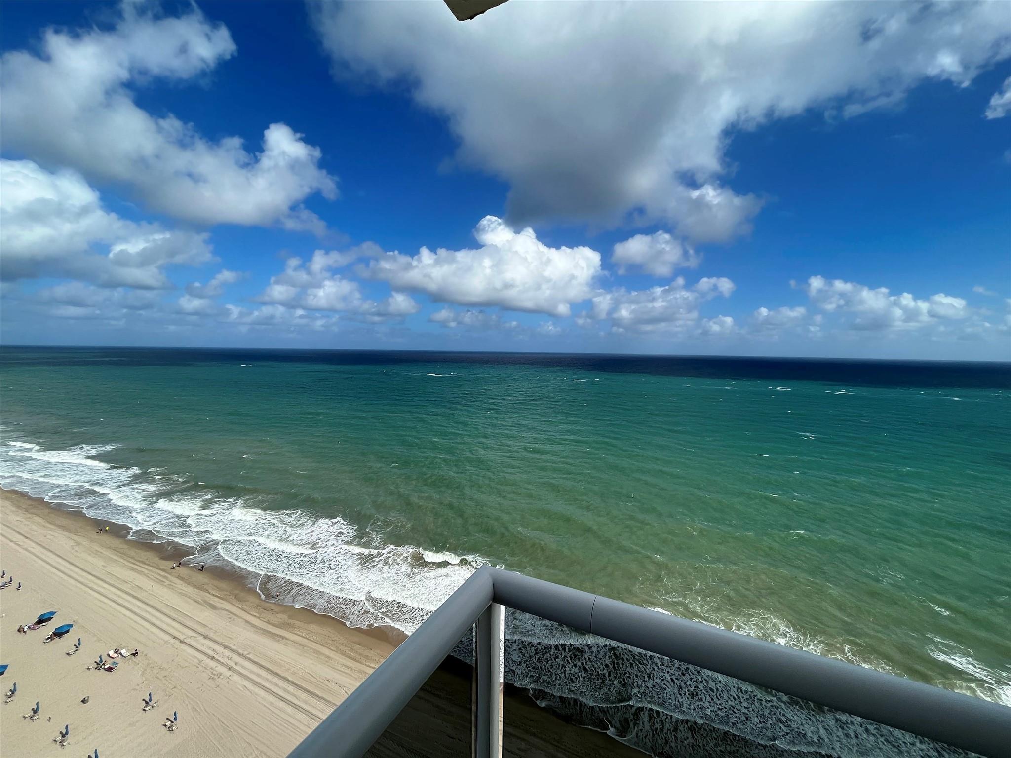 The NE edge of the wraparound balcony showing the unobstructed view of the ocean and beach.