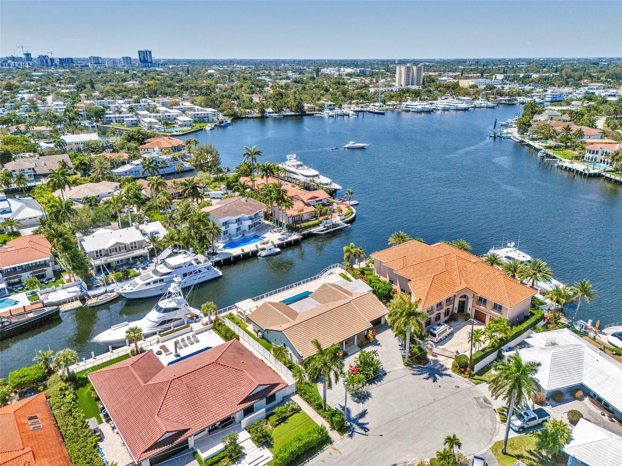 Aerial view of the residence facing northwest with wide turning basin on the Middle River in the background