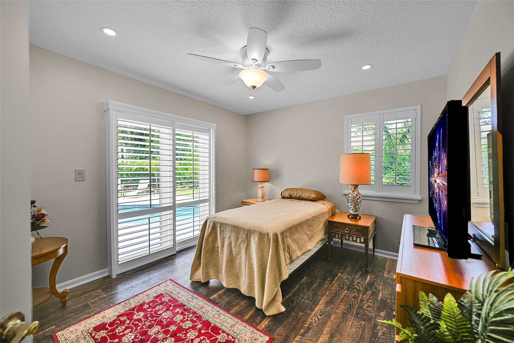 Sliding glass doors to beautiful backyard with sparkling pool