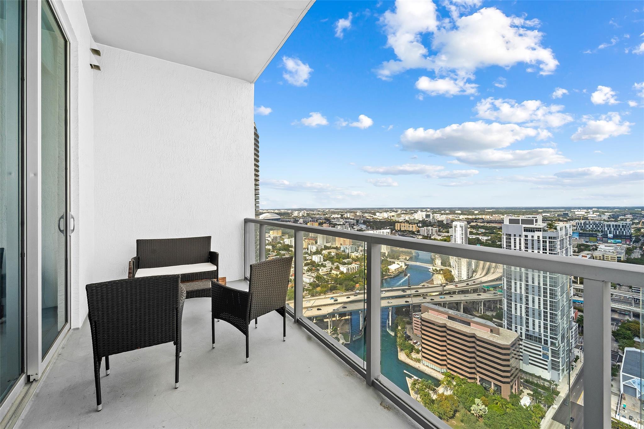 Oversized balcony with room for multiple outdoor spaces, panoramic views of Miami from East to West