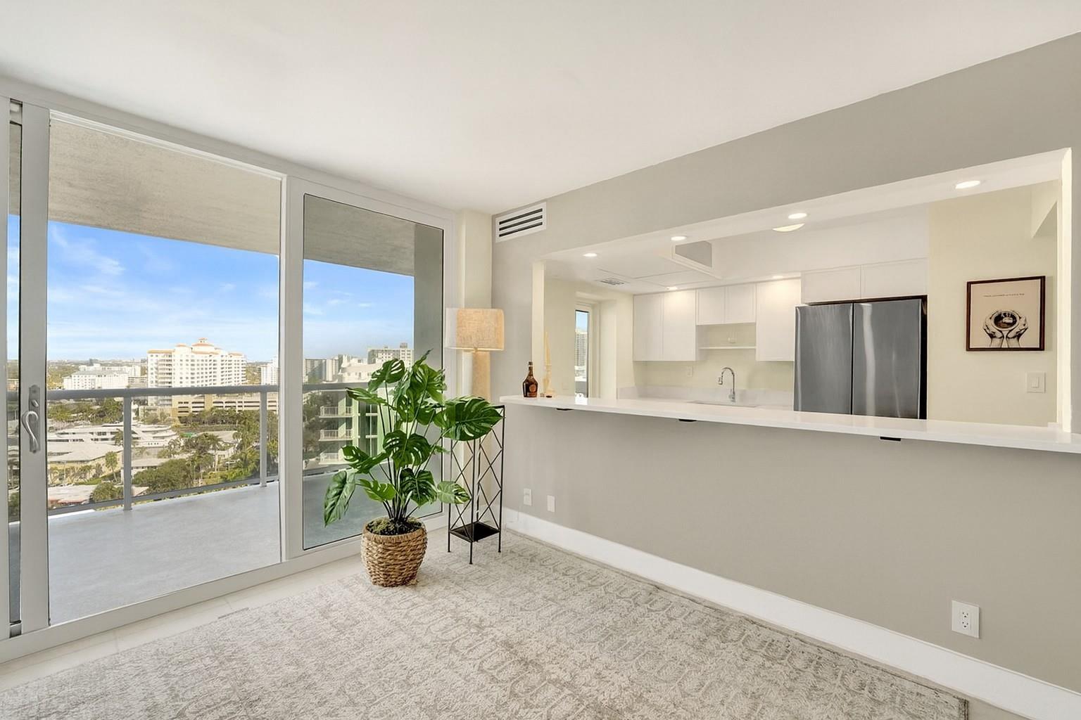 Open kitchen with all brand new, top of the line appliances and bar-height new quartz counter-tops.