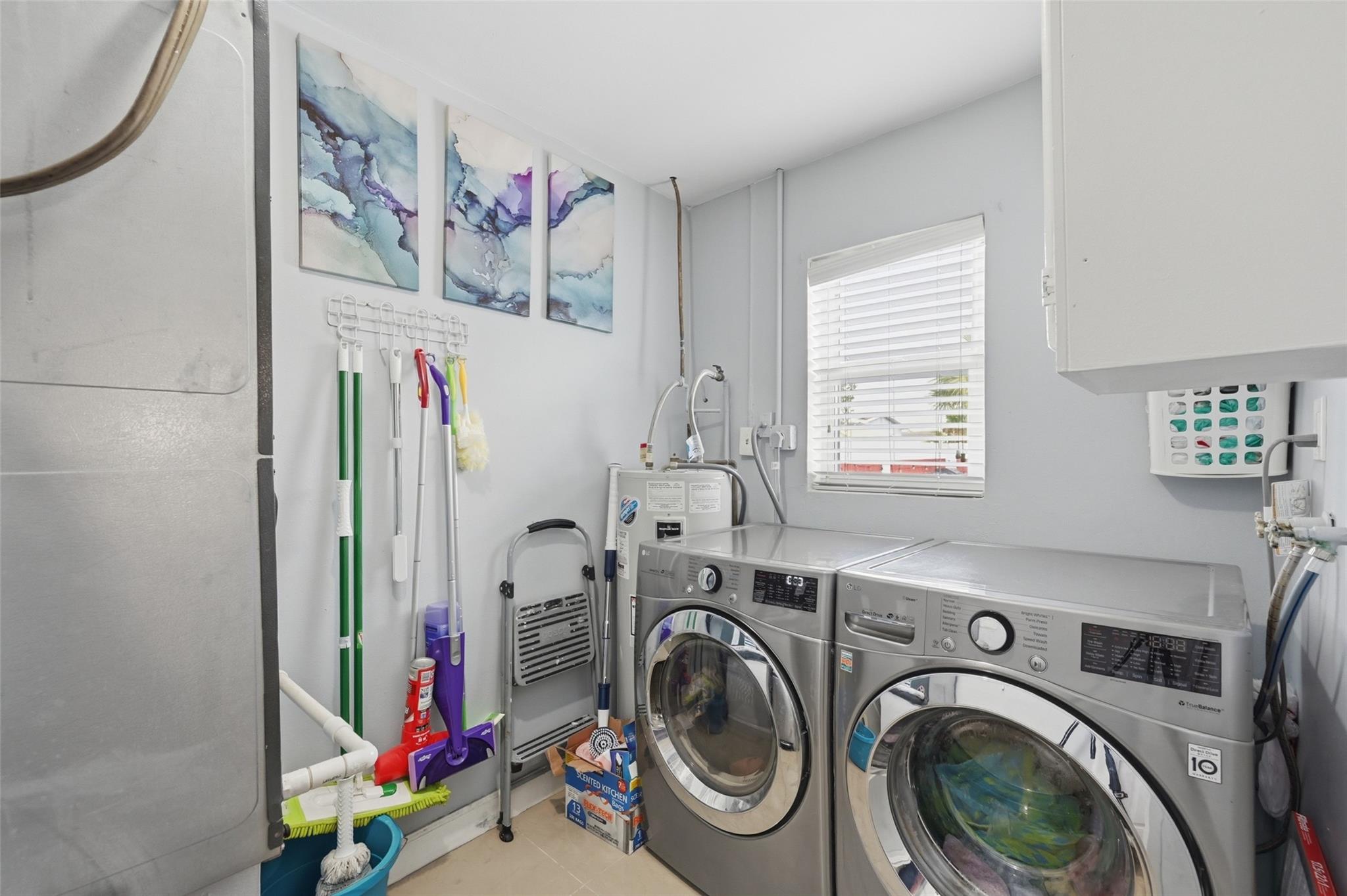 Laundry room with plenty of room for storage and it even has a window in it.