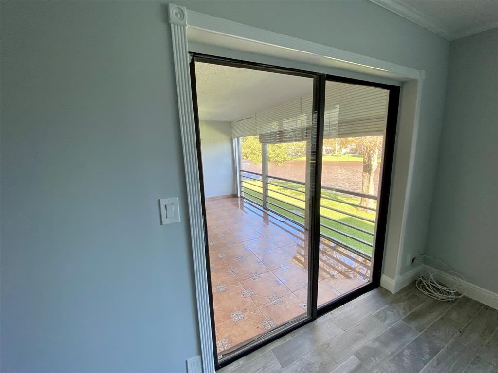 Photo for 2311 S Cypress Bend Drive, 219A, Pompano Beach, FL 33069 - Listing #FX-10412204 Sliding Door to Patio, showing tiled patio & Water View