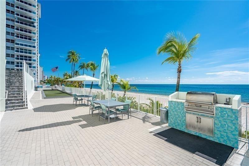 The lower beach deck has barbeque grills, the bocce court, stairs leading up to the tennis court, and plenty of seating.