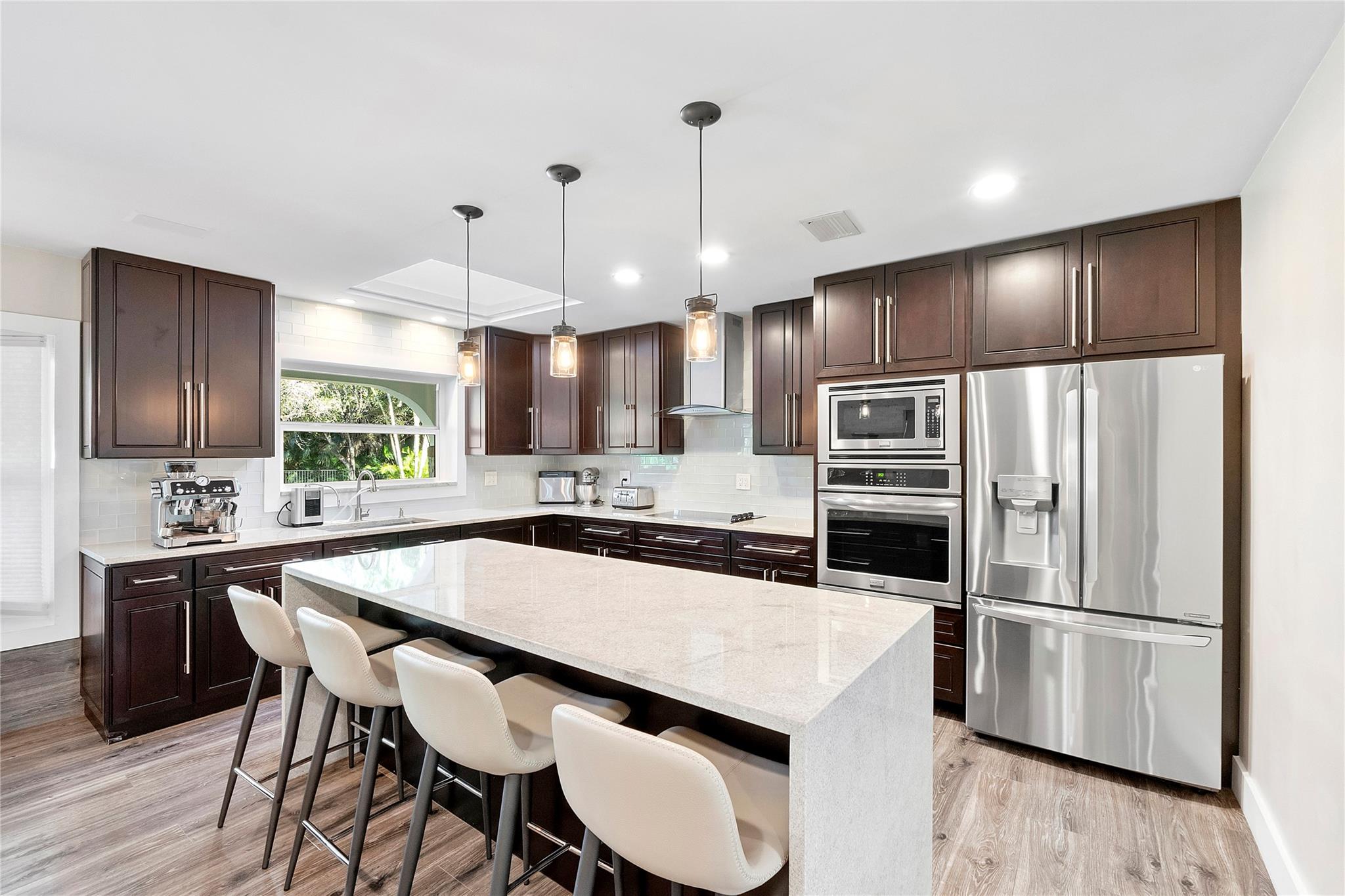 Beautiful granite countertops with a waterfall drop that look like Quartz and last a lot longer,