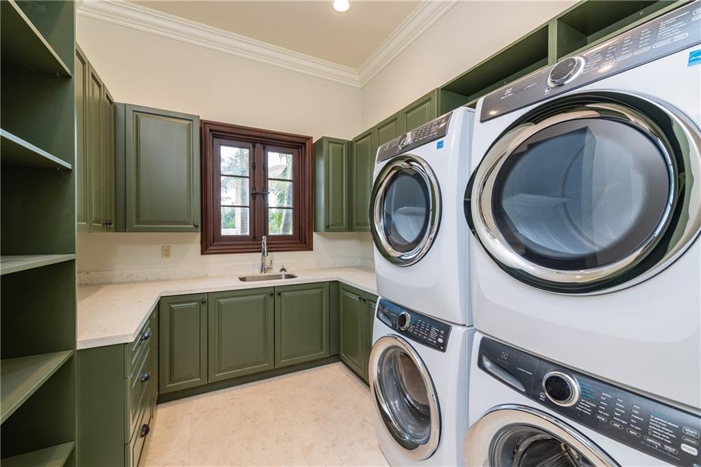 LAUNDRY ROOM WITH 2 SETS OF WASHERS AND DRYERS