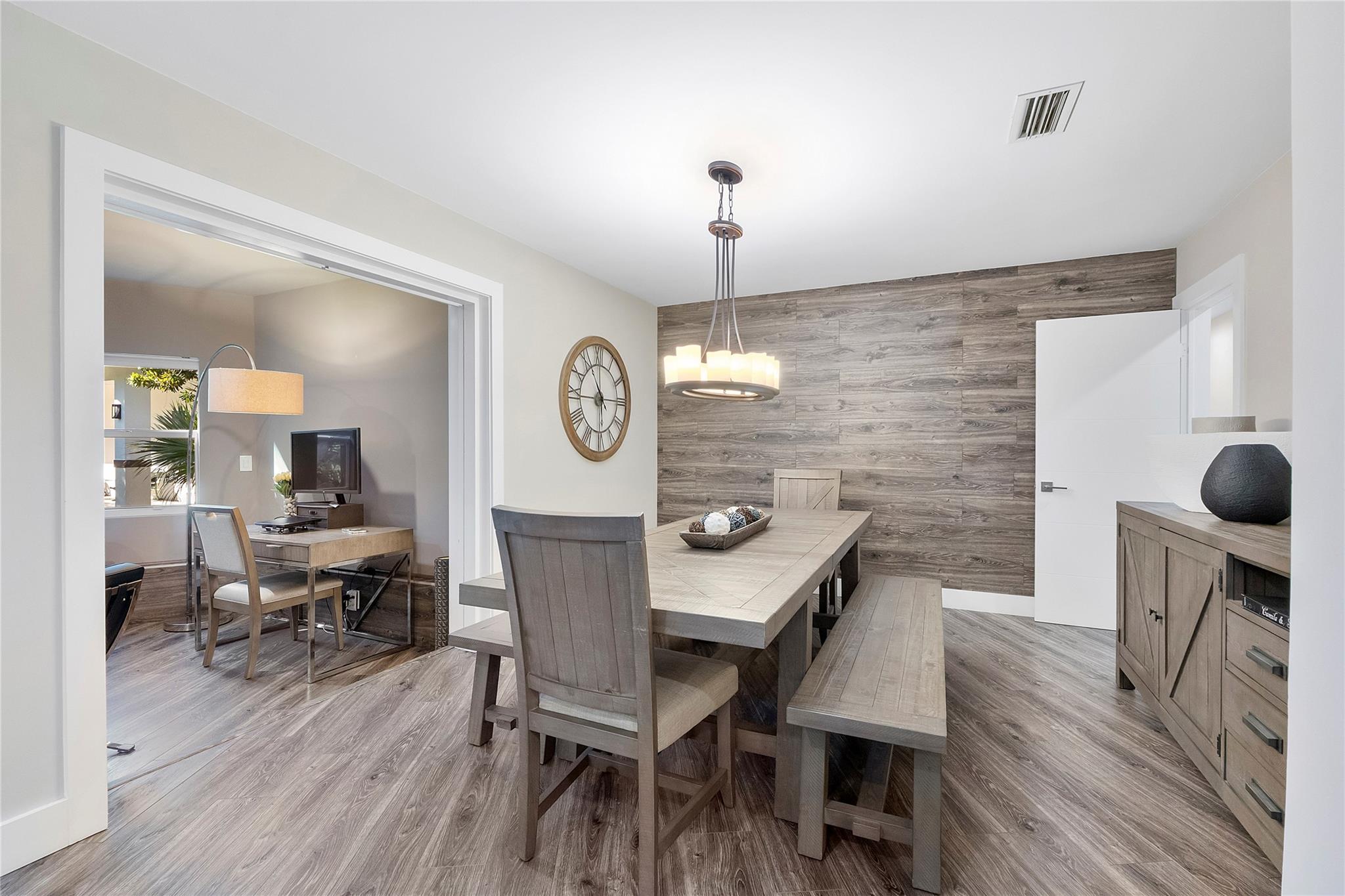 The Formal dining room opens up to the Piano sitting room or den,