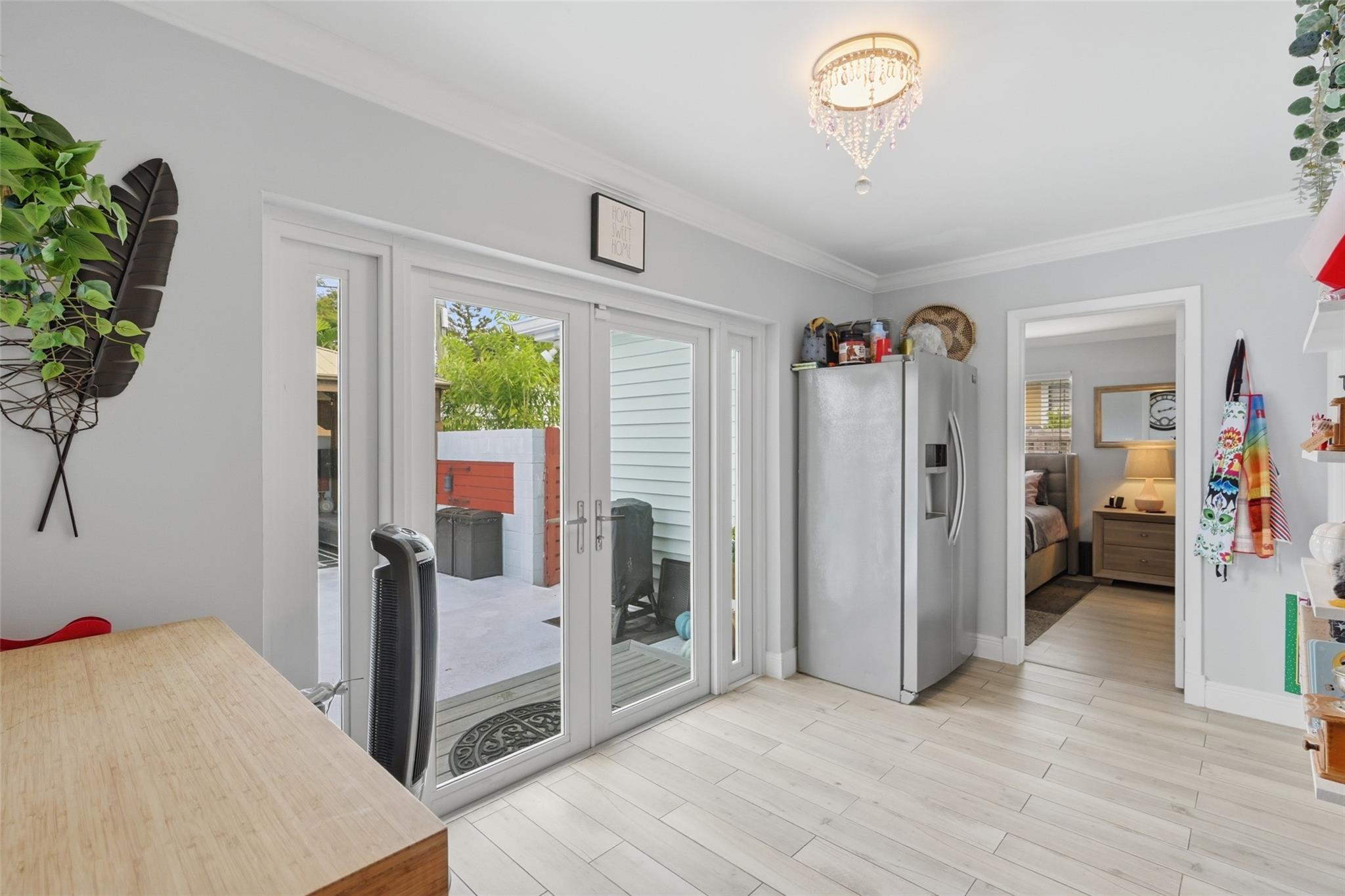 This is the second refrigerator. Your kitchen has a space for a small table. Impact doors going out to your pool.