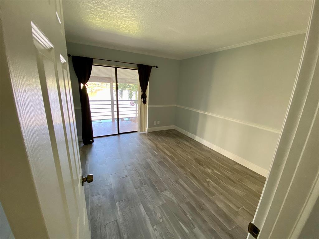 Photo for 2311 S Cypress Bend Drive, 219A, Pompano Beach, FL 33069 - Listing #FX-10412204 Roomy 2nd bedroom, w/Water View & Glass Doors to Patio