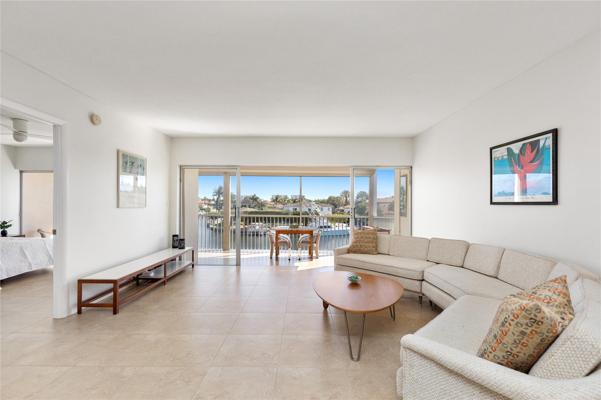 Living area with waterway in background off large balcony