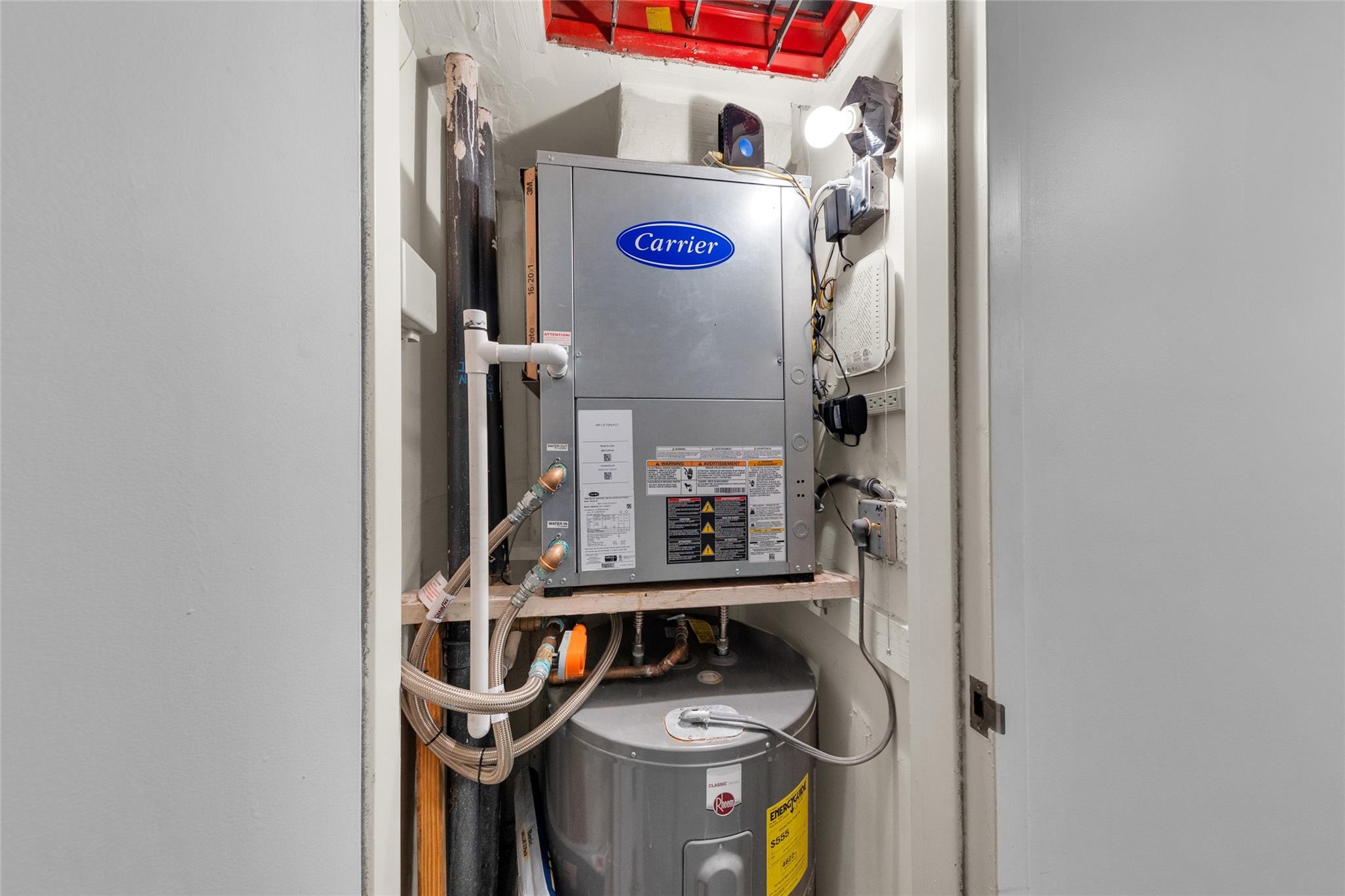 Newer AC and hot water heater located in a closet outside the unit