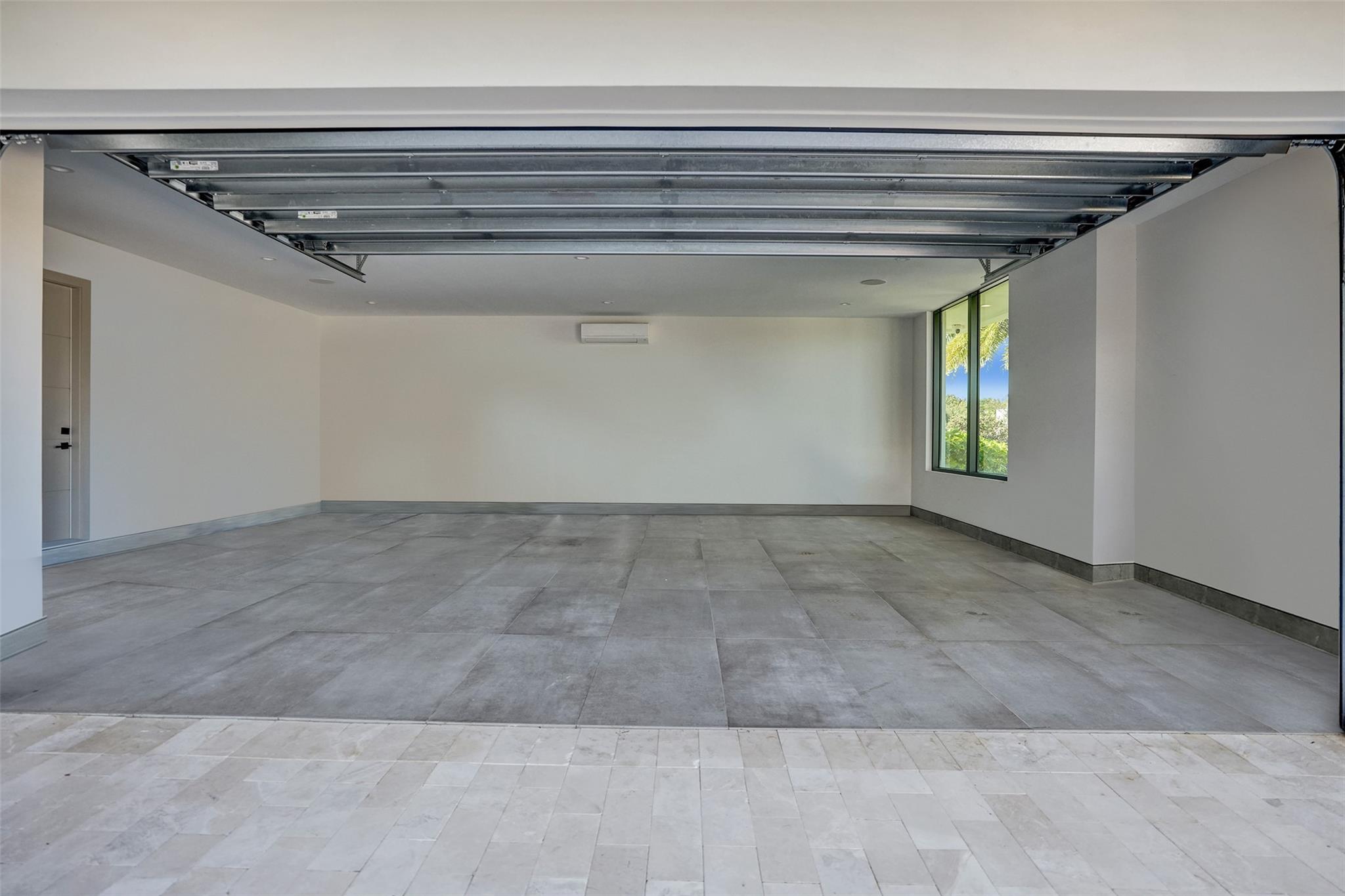 The larger of the 2 car garage bays measuring approx 672 sq feet (24' wide x 28' deep)