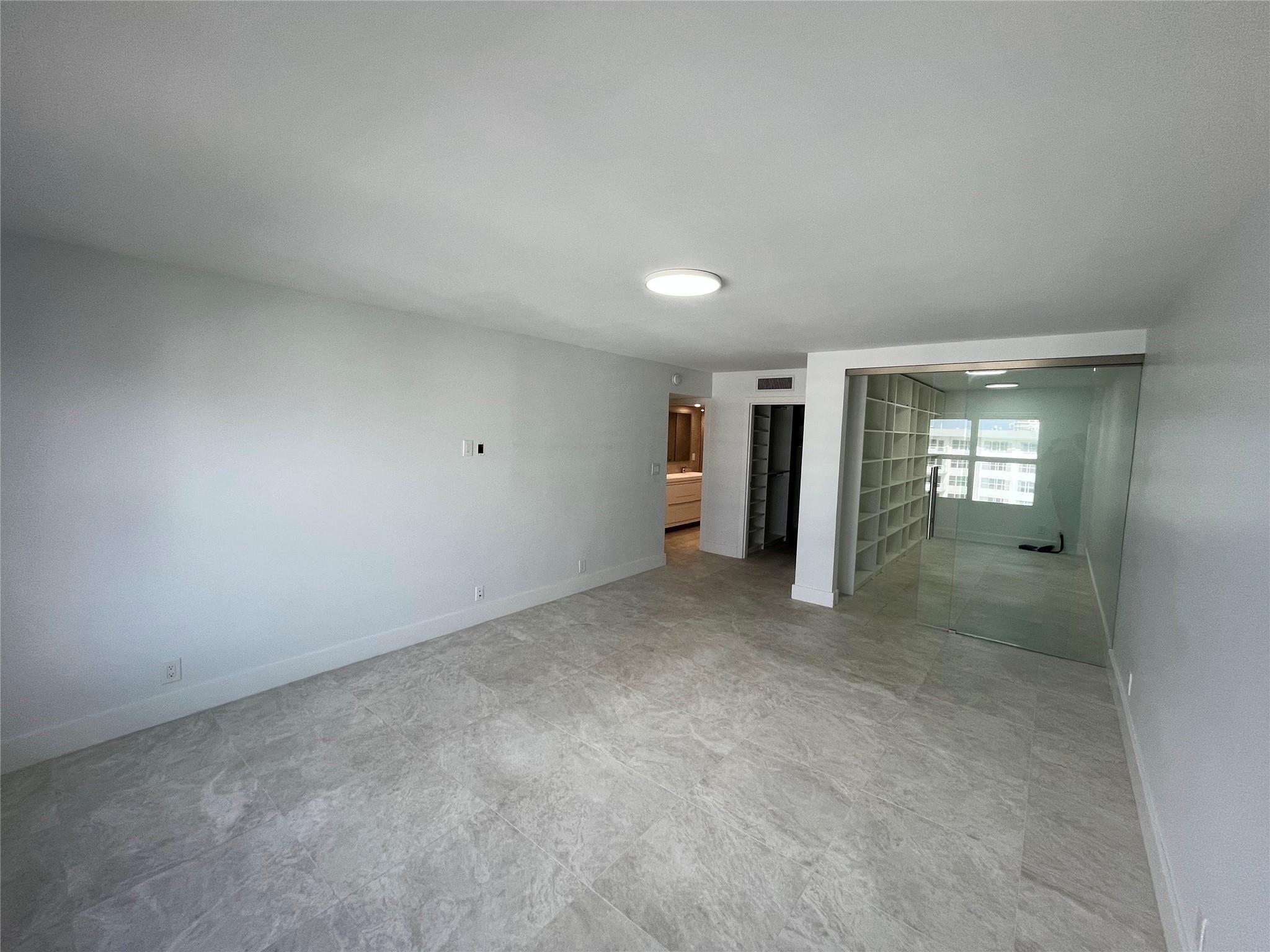 The master bedroom includes a separate sliding glass door room which may be utilized as an office or den.