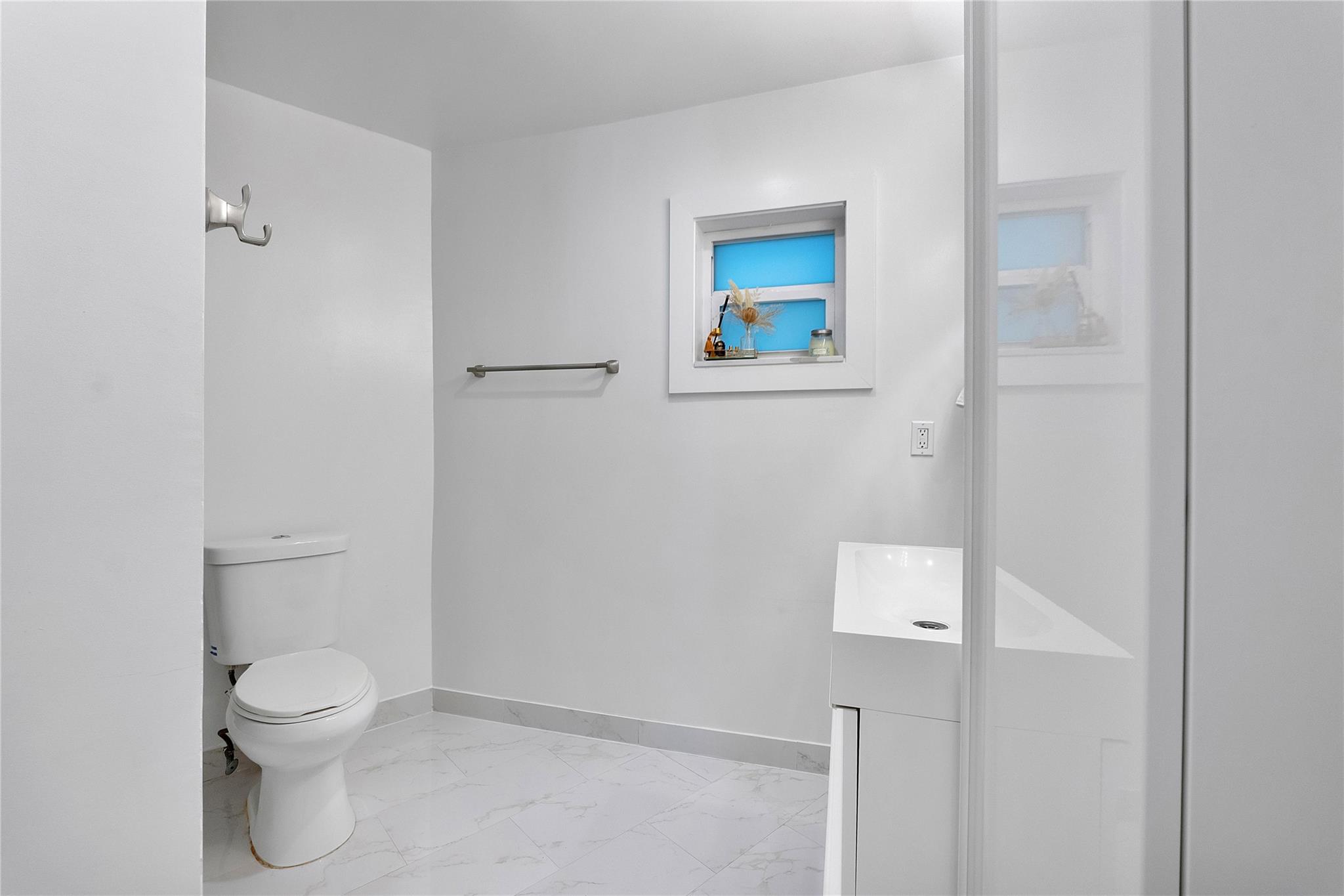 What a pretty bathroom ready for some towels on the towel holder and your robe hanging on the hook,