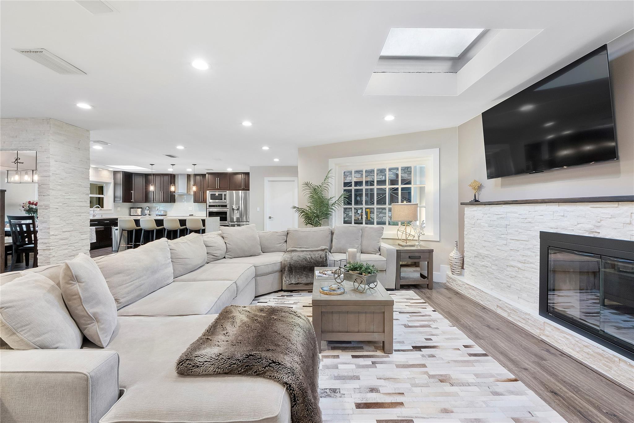 The family room is huge and sprawls into the kitchen & dining room and open living areas, A stone fireplace with a real living log fire and chimney