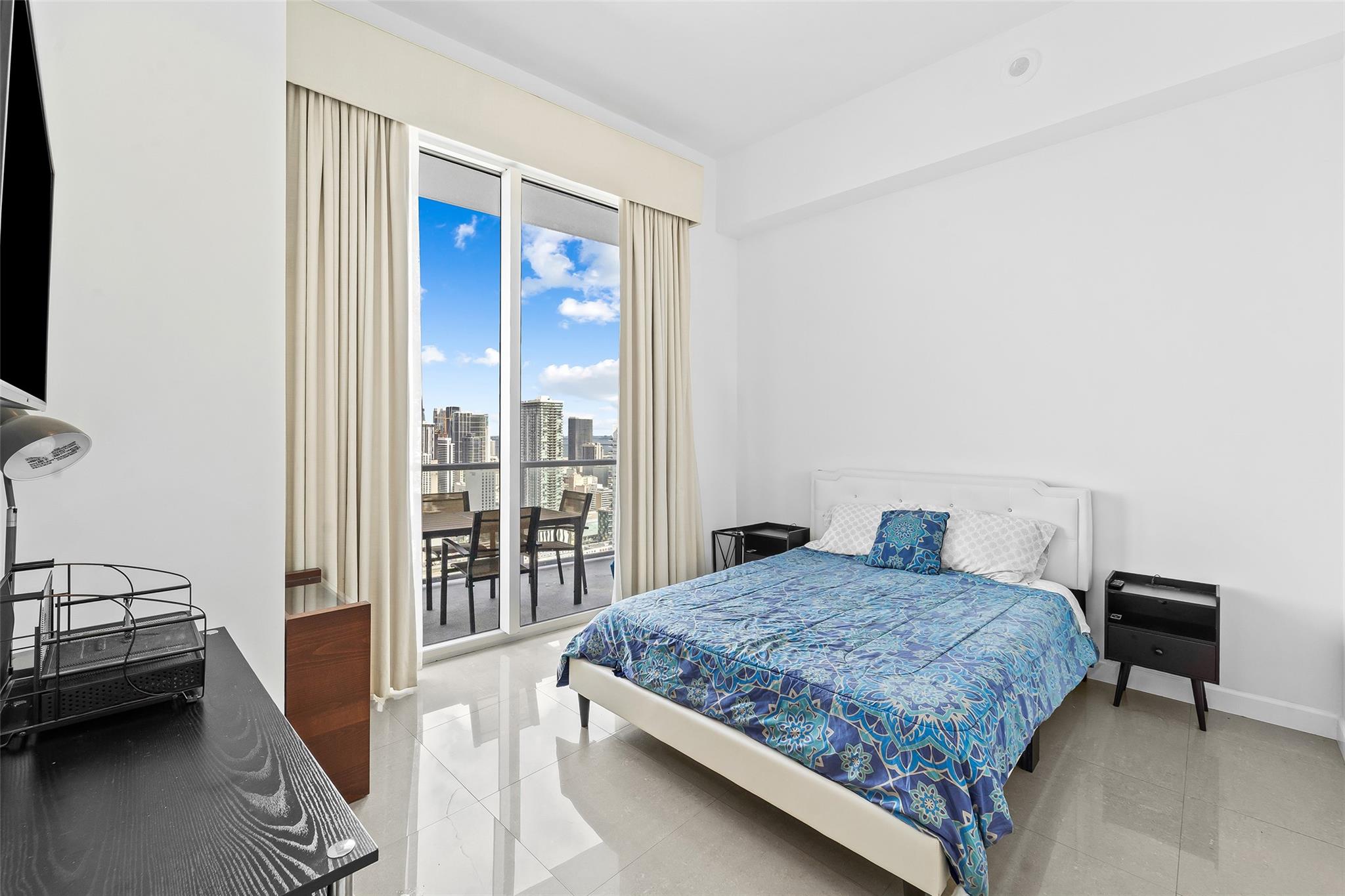 Guest Bedroom with volume 12-foot ceilings and balcony access