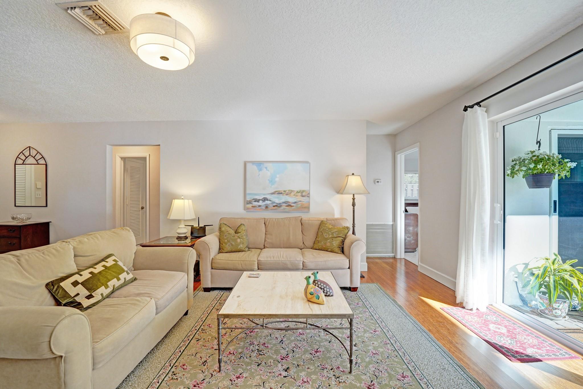 Open and bright living room with lovely backyard views.