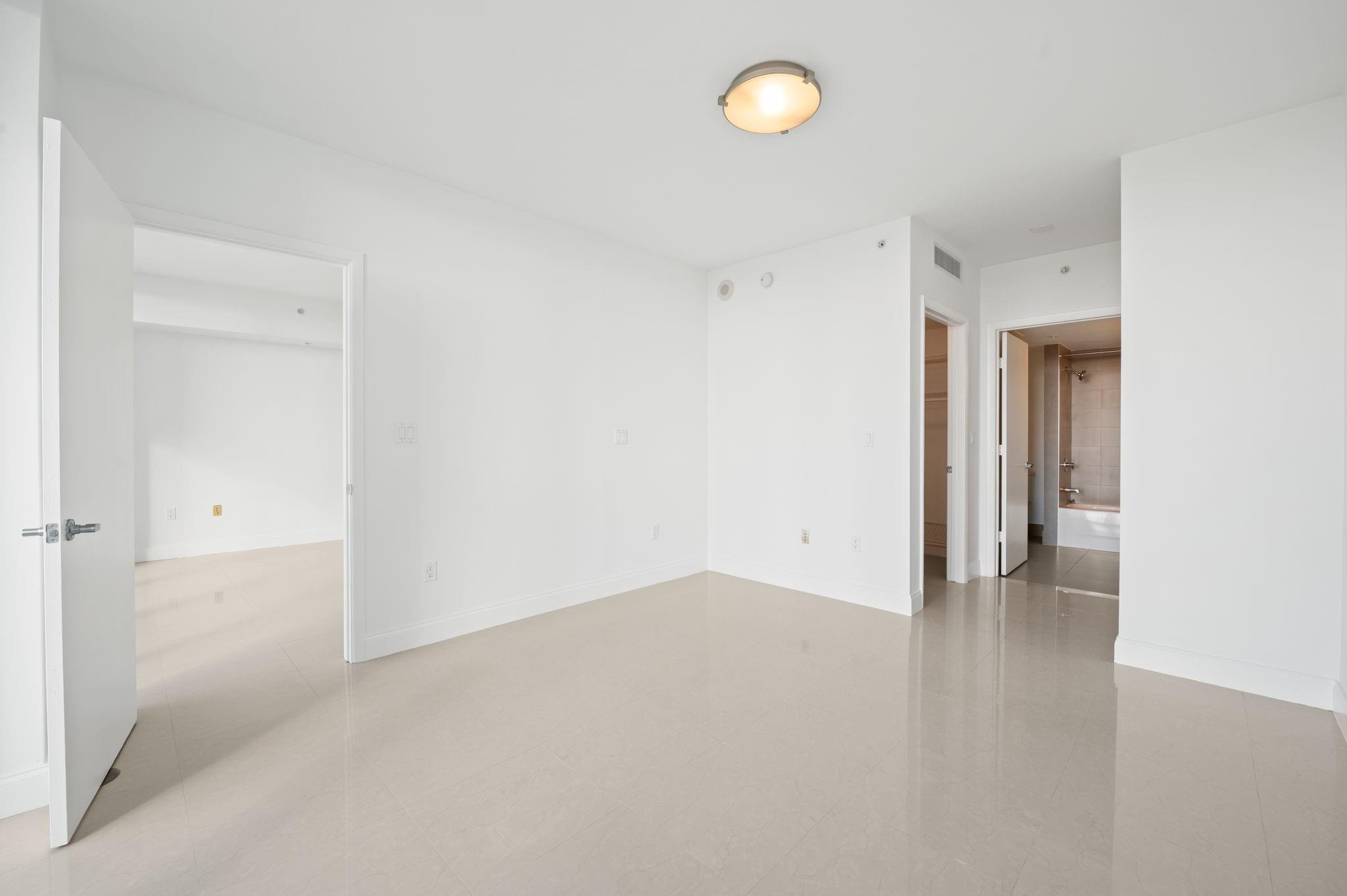 PRIMARY BEDROOM WITH ENSUITE BATH, WALK-IN CLOSET AND SECOND WALL CLOSET