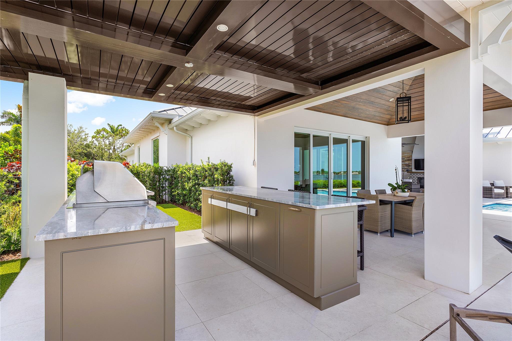 The summer kitchen/ loggia/ resort-style pool reflect theenvironment of elegant casual entertaining