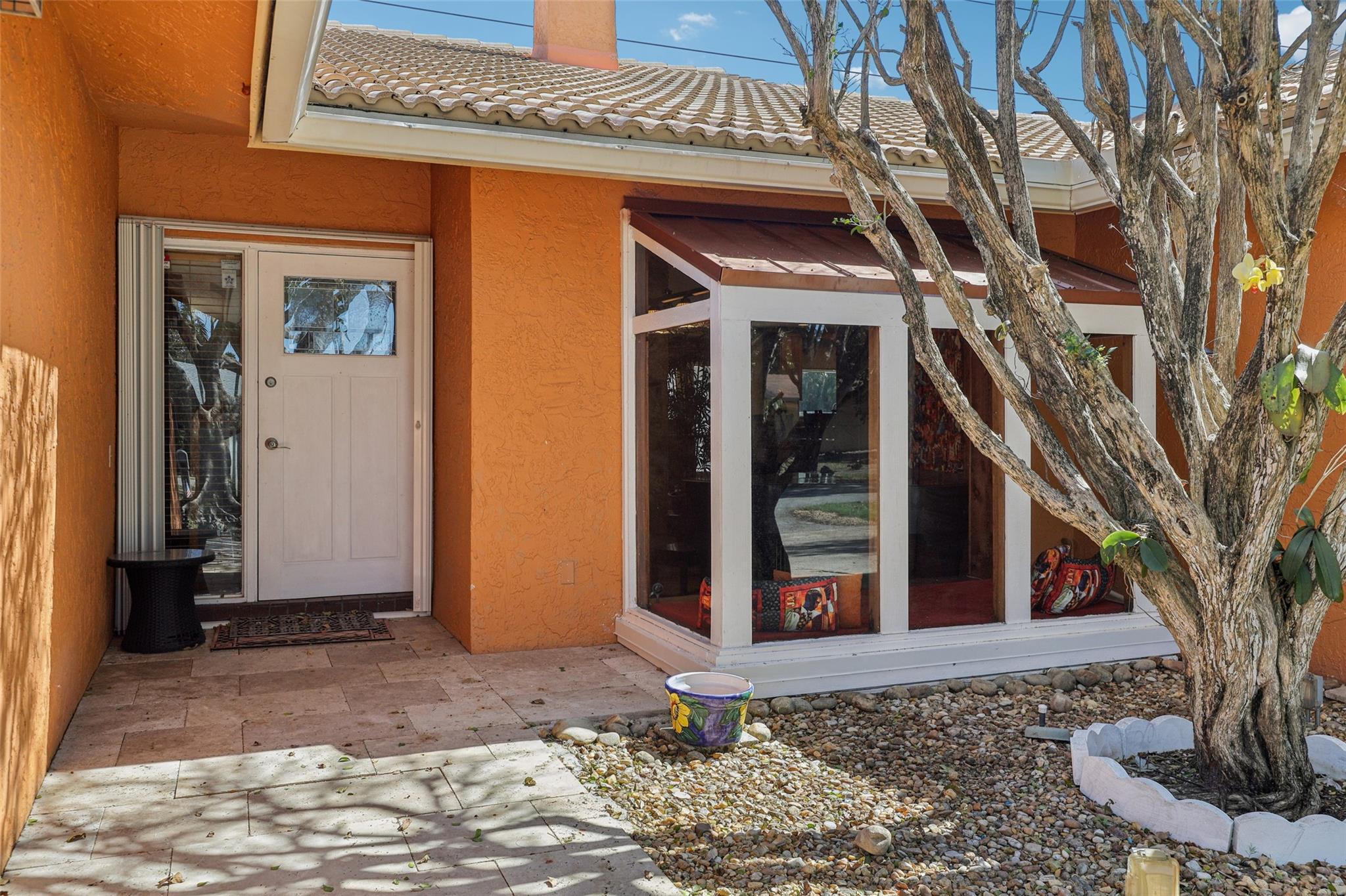 Walkway to front door with shade from trees and atrium.
