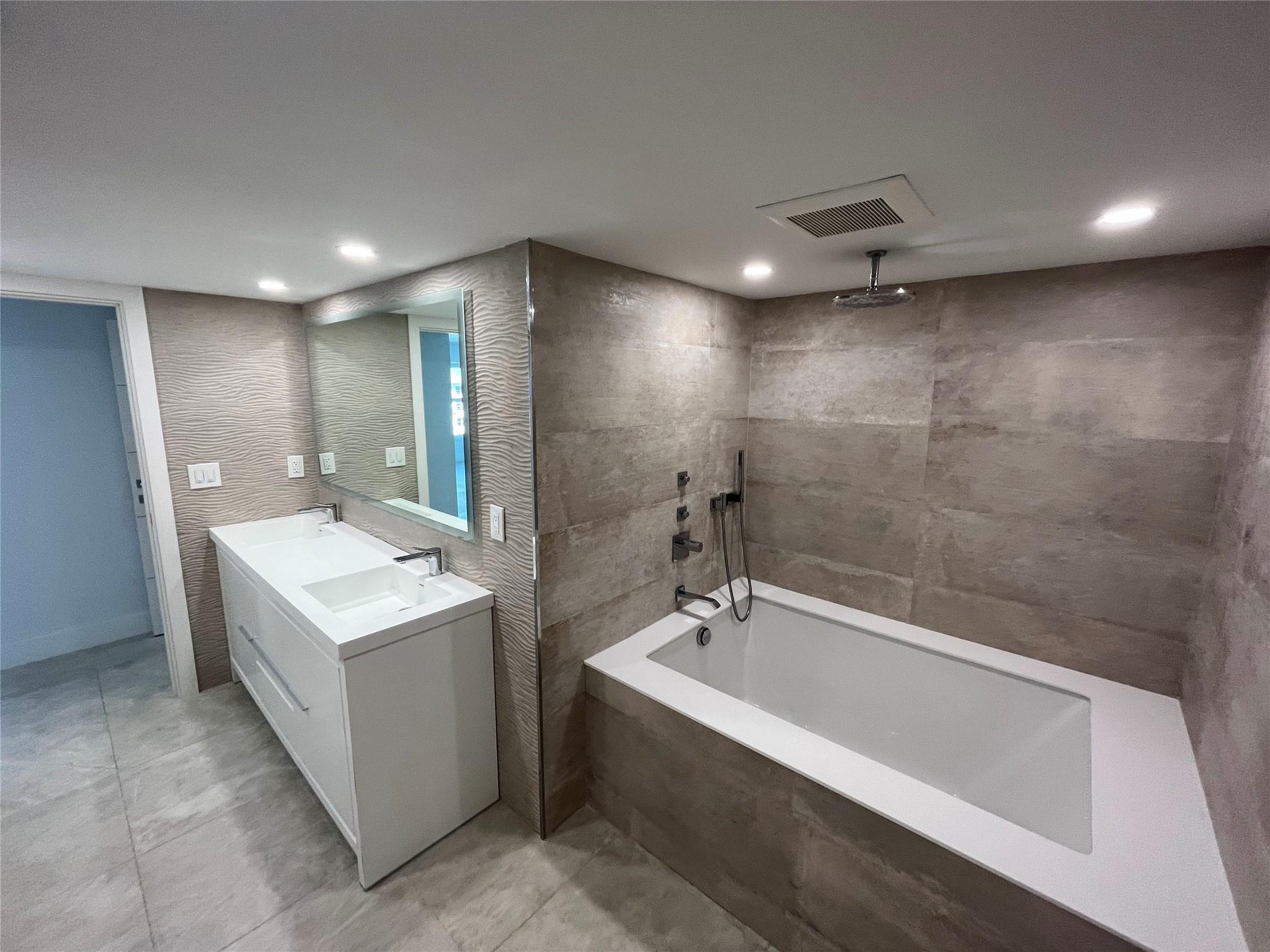 Besides a soaking tub the master bathroom features a rain fall showerhead.