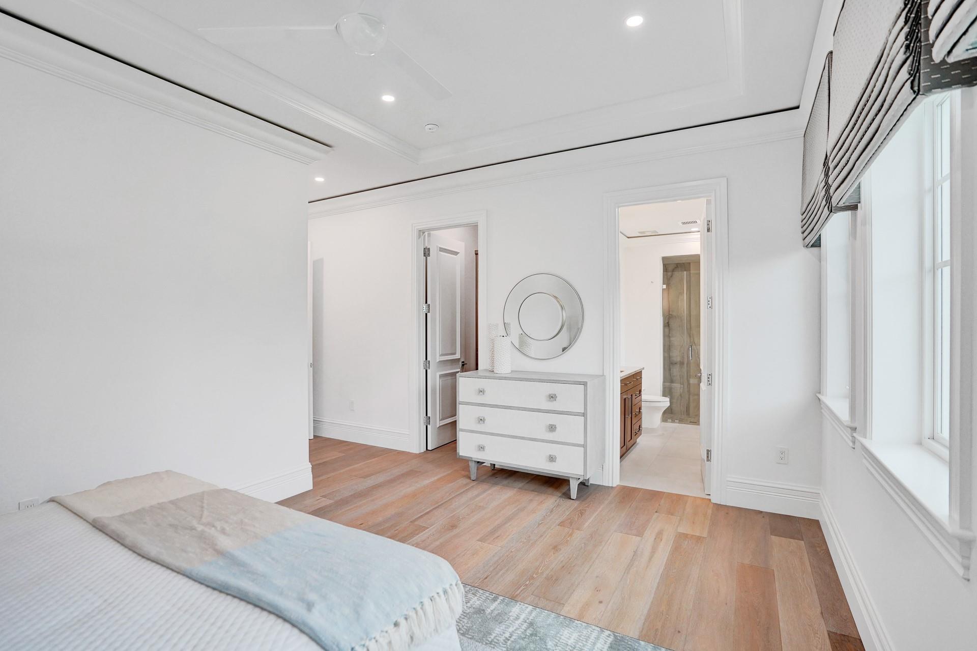 Spacious guest bedroom with walk-in closet and ensuite bathroom.