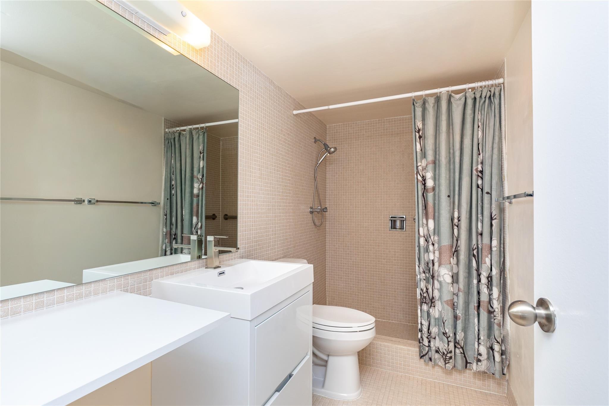 Primary bathroom with updated modern vanity.