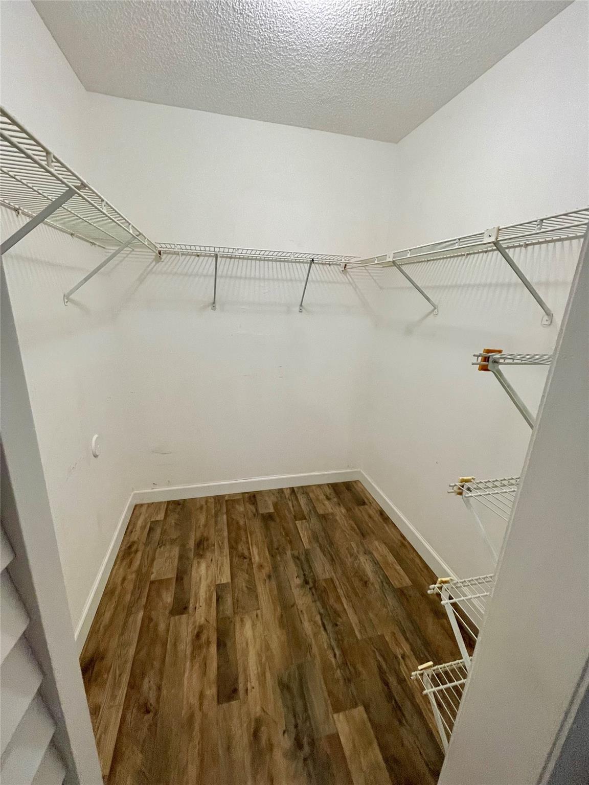 Walk-in closet in primary bedroom.