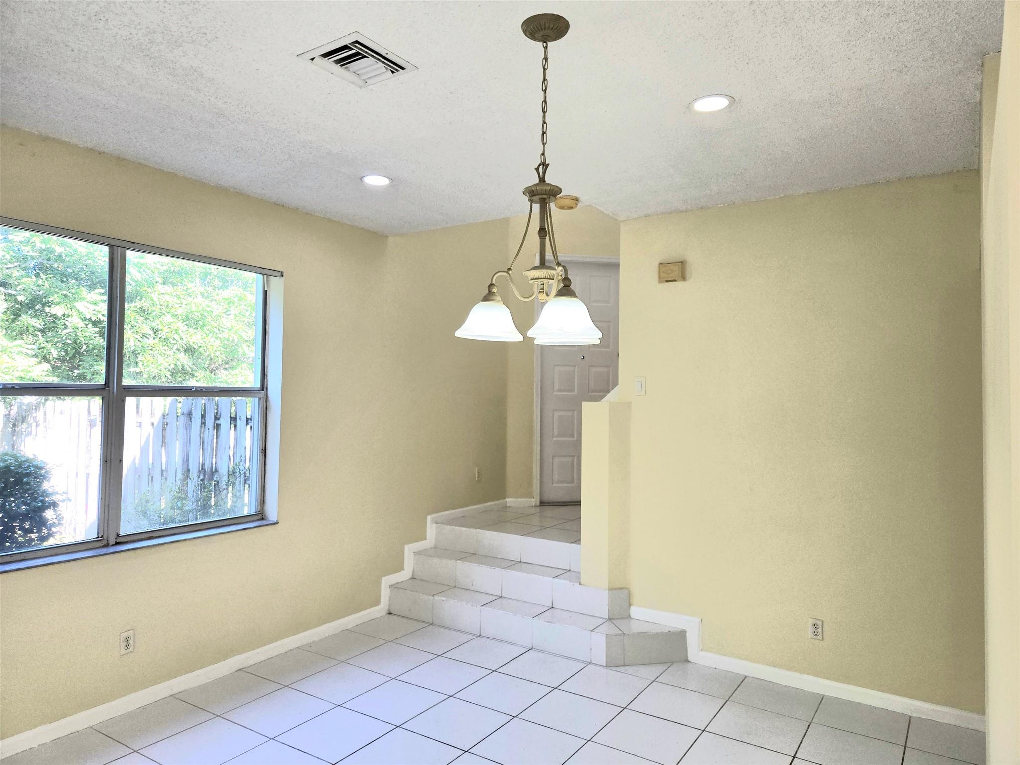 Foyer with stairs that lead to the second story.