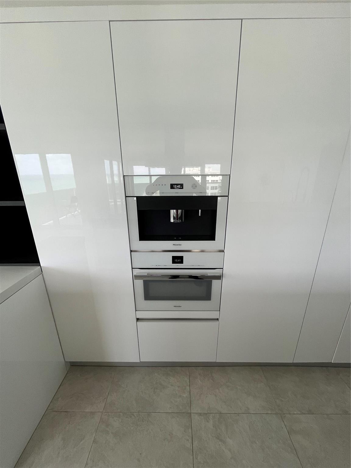 The top-of-the-line kitchen features two built-in Miele® ovens including convection and microwave.