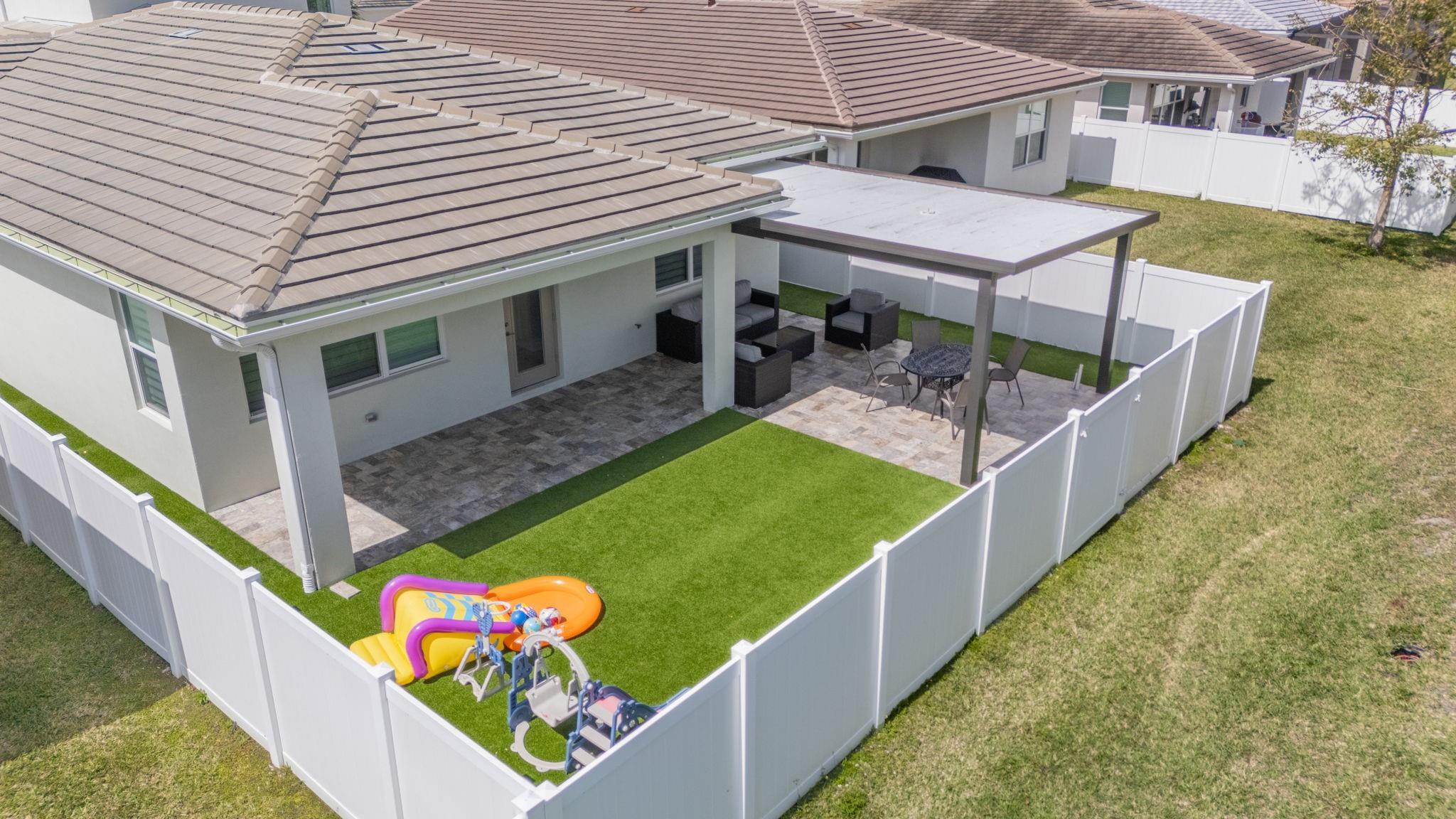 Yes! That's a Pergola. Stay Cool with an Elegant Overhang with extended Travertine Tile at the Rear Patio and Pergola.
