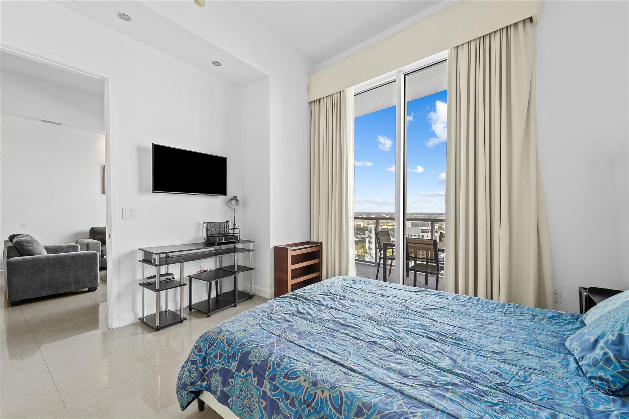 Guest Bedroom with volume 12-foot ceilings and balcony access