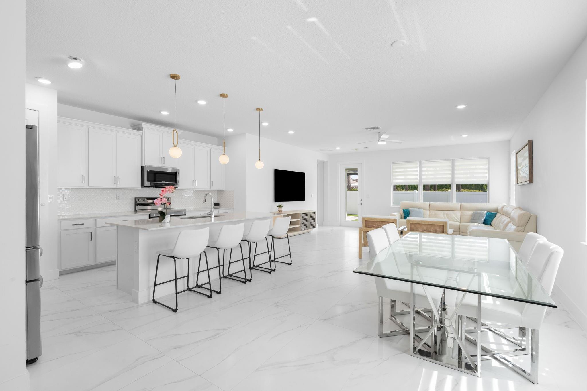 Step into a beautifully updated Living Room, Dining Room and Living Room complete with Modern Lighting and Dual Roller Shades and Porcelain Tile Throughout the First Floor. No Carpet in the home.